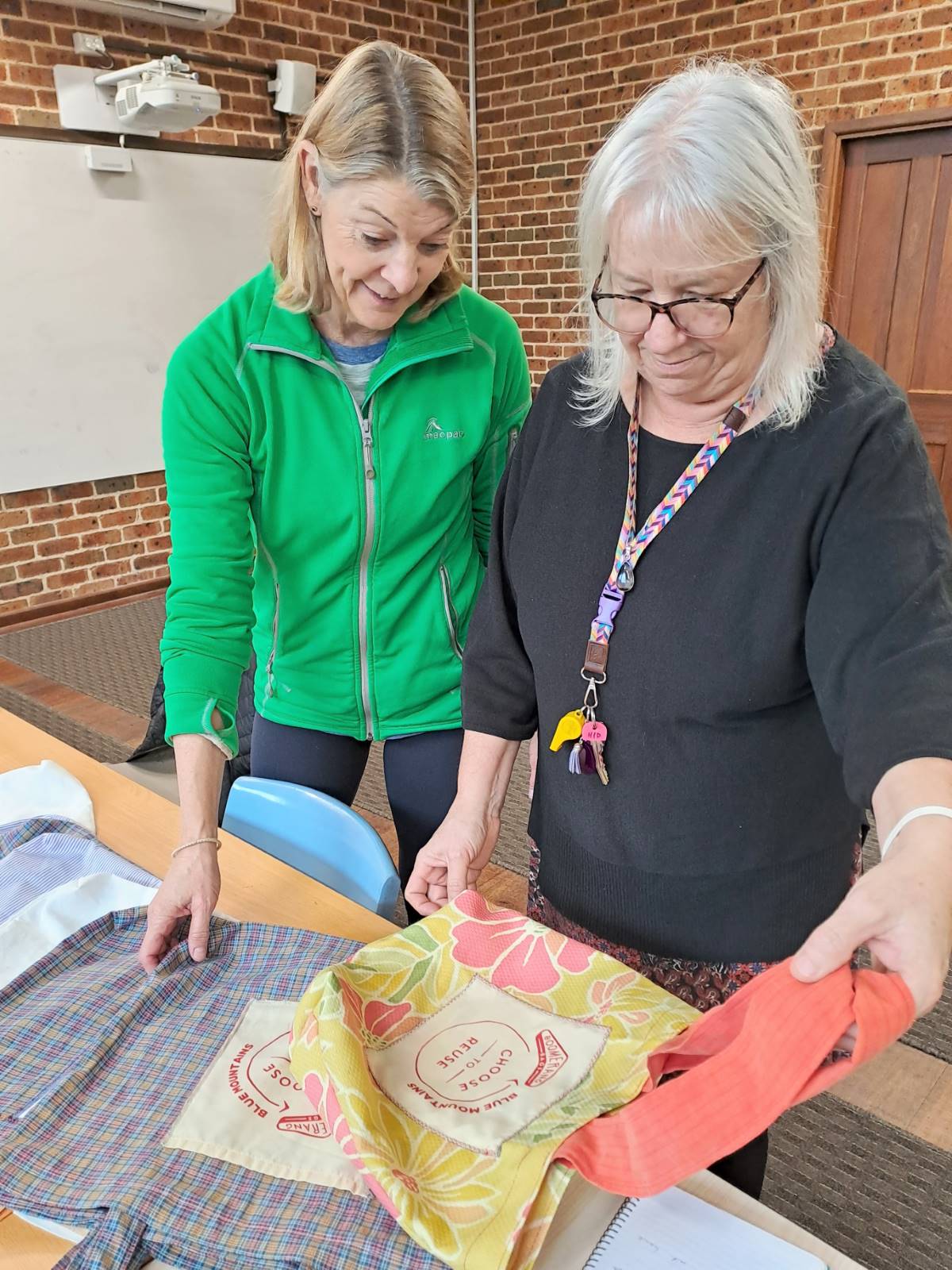 Alison and Maria admiring the various fabrics donated to the group.