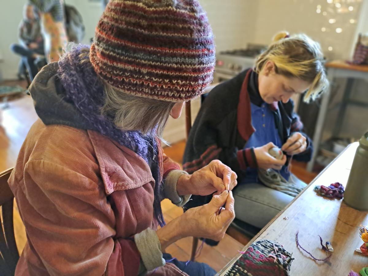 Community members mending old clothes at former Lyttleton Stores last year.